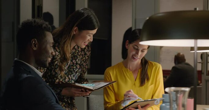 business people working late using tablet computer in office team leader woman discussing ideas with colleagues brainstorming for project deadline 