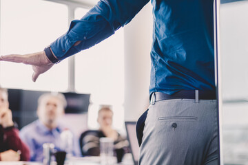 Business man making a presentation on corporate meeting.