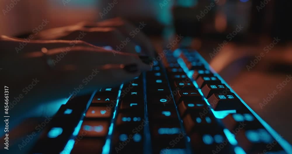 Wall mural close up hands typing on keyboard programmer coding software gamer using keyboard with blue backligh