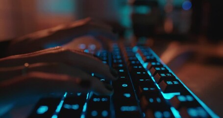 close up hands typing on keyboard programmer coding software gamer using keyboard with blue backlight playing game at night - Powered by Adobe