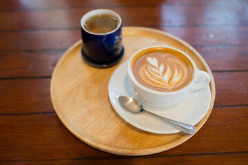 hot latte art coffee on wood table, relax time
