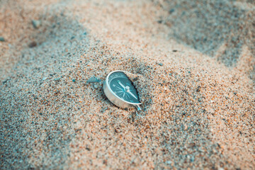 Сompass on the hot sand. Selective focus. Shallow depth of field.
