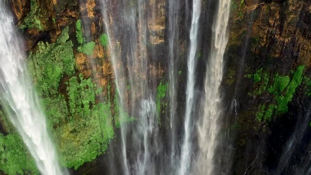 View from above, stunning aerial footage of the Tumpak Sewu Waterfalls Coban Sewu.The highest waterfalls in Indonesia. Tumpak Sewu Waterfalls in East Java, Indonesia. Southeast Asia