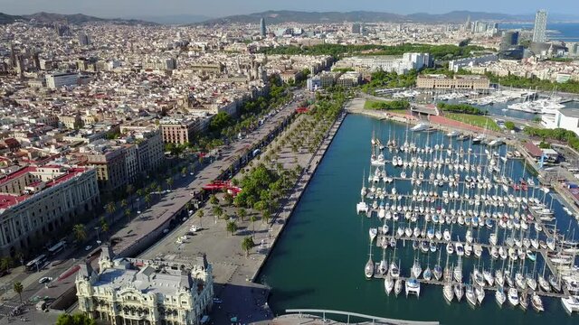Cinematic 4K aerial drone footage of the Port of Barcelona, Moll de la Fusta with the marina and downtown Barcelona in view