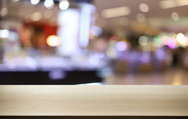 Empty wooden table in front of abstract blurred background of coffee shop . can be used for display or montage your products.Mock up for display of product