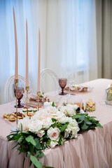 Wedding catering table in powdery pink color. Different food appetizers and snacks
