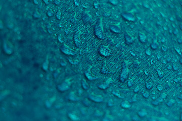 water beading on fabric. Waterproof coating background with water drops