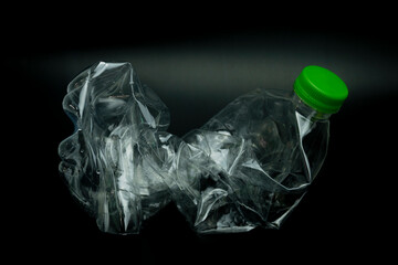 twisted plastic bottle isolated on black background