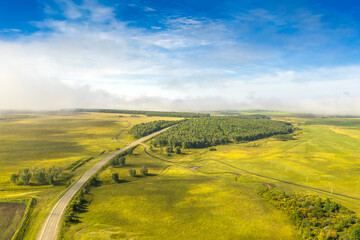 Fog rising in an early summer morning over the fields and the road. Siberia, Russia  © Kirill  Sergeev