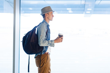 Obraz premium Young male passenger at the airport waiting for her flight