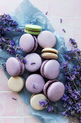 Obraz na płótnie Canvas French macarons with lavender flavor and fresh lavender flowers
