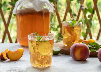 Kombucha tea slightly alcoholic, lightly effervescent drink with peach and lime. Homemade...