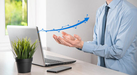 Businessman hold drawing on screen growing graph, arrow of positive growth icon.pointing at creative business chart with upward arrows.Financial, business growth concept.