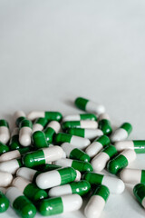 Different medical capsules and pills at white background with copy space