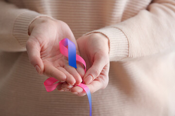 Woman with colorful ribbon, closeup. Thyroid cancer awareness concept