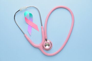 Colorful ribbon and stethoscope on blue background. Thyroid cancer awareness concept
