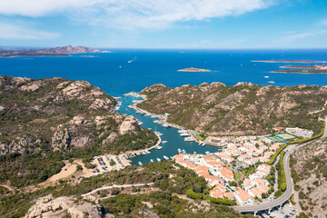 View from above, stunning aerial view of the village of Poltu Quatu with its beautiful harbour full of boats and luxury yachts. Sardinia, Italy.