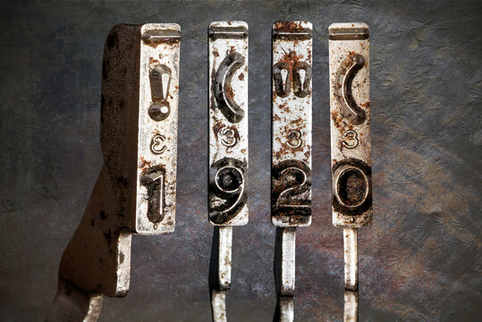 vintage old typewriter hammers with the date 1920 with vintage wallpaper background