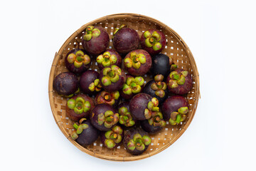 Mangosteen in bamboo basket on white background.