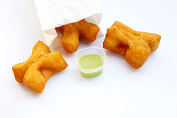 Deep-fried dough sticks or chinese bread sticks on white background.