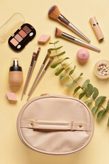 Stylish bag and decorative cosmetics on color background