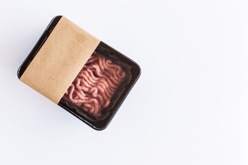 fresh raw minced meat in plastic vacuum packaging on a white background. top view. logo layout design.