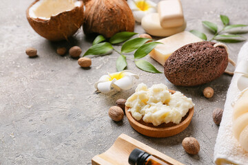 Fototapeta na wymiar Composition with shea butter, nuts and bath supplies on grunge background, closeup