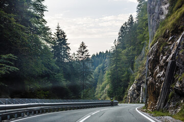 Road turning in the mountains, Alps background