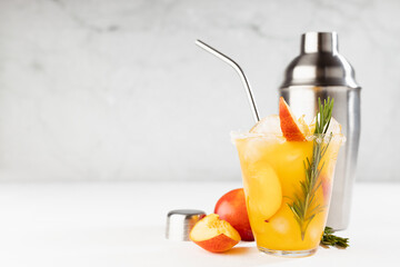 Cooking of homemade vitamin summer fresh orange peach lemonade with ice, green rosemary twig, sugar...