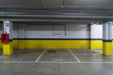 Empty parking spaces in the parking lot of a shopping center. Underground parking without cars. 