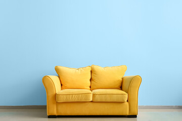 Fototapeta na wymiar Comfortable sofa near color wall