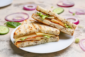 Plate with tasty sandwiches on light background, closeup