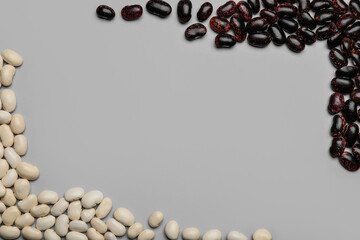 Raw beans on grey background