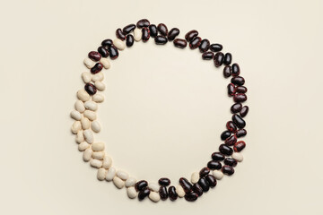 Frame made of raw beans on white background