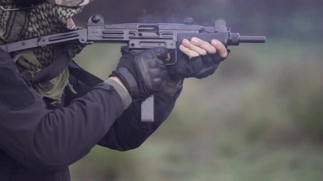 COMANDO SHOOTING A UZI MACHINE GUN