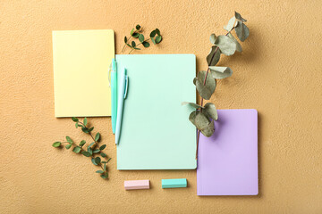 Set of stationery supplies and plant branches on color background