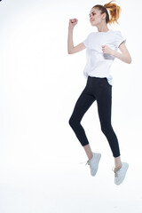 pretty woman in white t-shirt energy jumping port light background