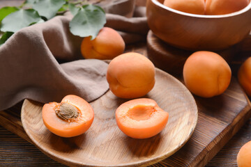 Tasty ripe apricots on wooden background