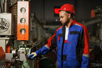 Portrait of african american male handyman working in an industrial factory