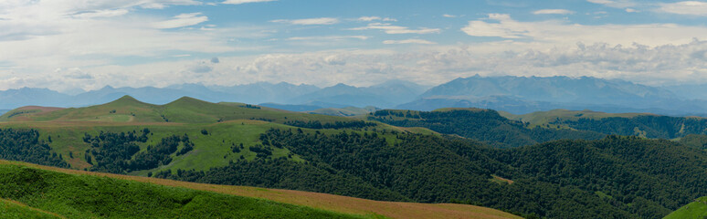 Fototapeta na wymiar Panoramic view of green hills and mountains