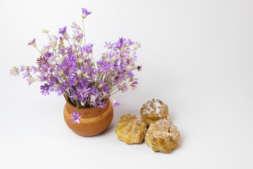horizontal shot Eclairs or profiteroles with custard inside on a whait background. Traditional French dessert. Empty space for design text template
