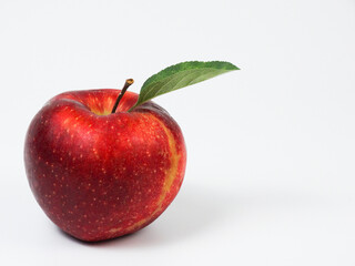 Red ripe apple with green leaf isolated on white background with  free space for text	