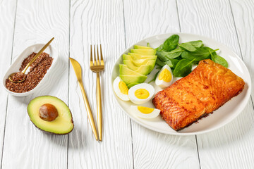 baked salmon fillet with eggs , spinach, avocado