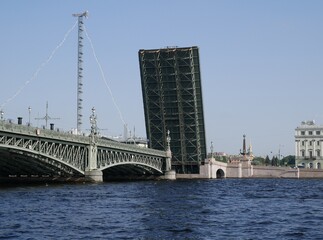 A Trinity Bridge drawbridge across the Neva River in St. Petersburg on a sunny summer day. A drawbridge connecting Vasilyevsky Island and the central part of the city. 