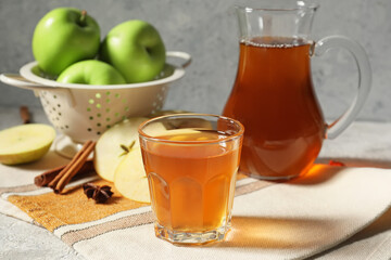 Glass of apple juice on table