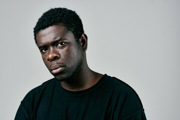 Obraz premium handsome man of african appearance in black t-shirt pensive look