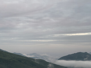 a beautiful view of mountains with clouds at dawn