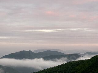 a beautiful view of mountains with clouds at dawn