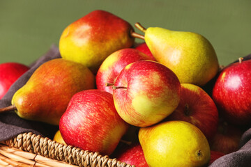 Naklejka na ściany i meble Box with ripe pears and apples on table, closeup
