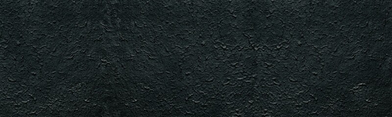 Black rough textured wall surface. Dark wide large texture. Abstract gloomy panoramic background
